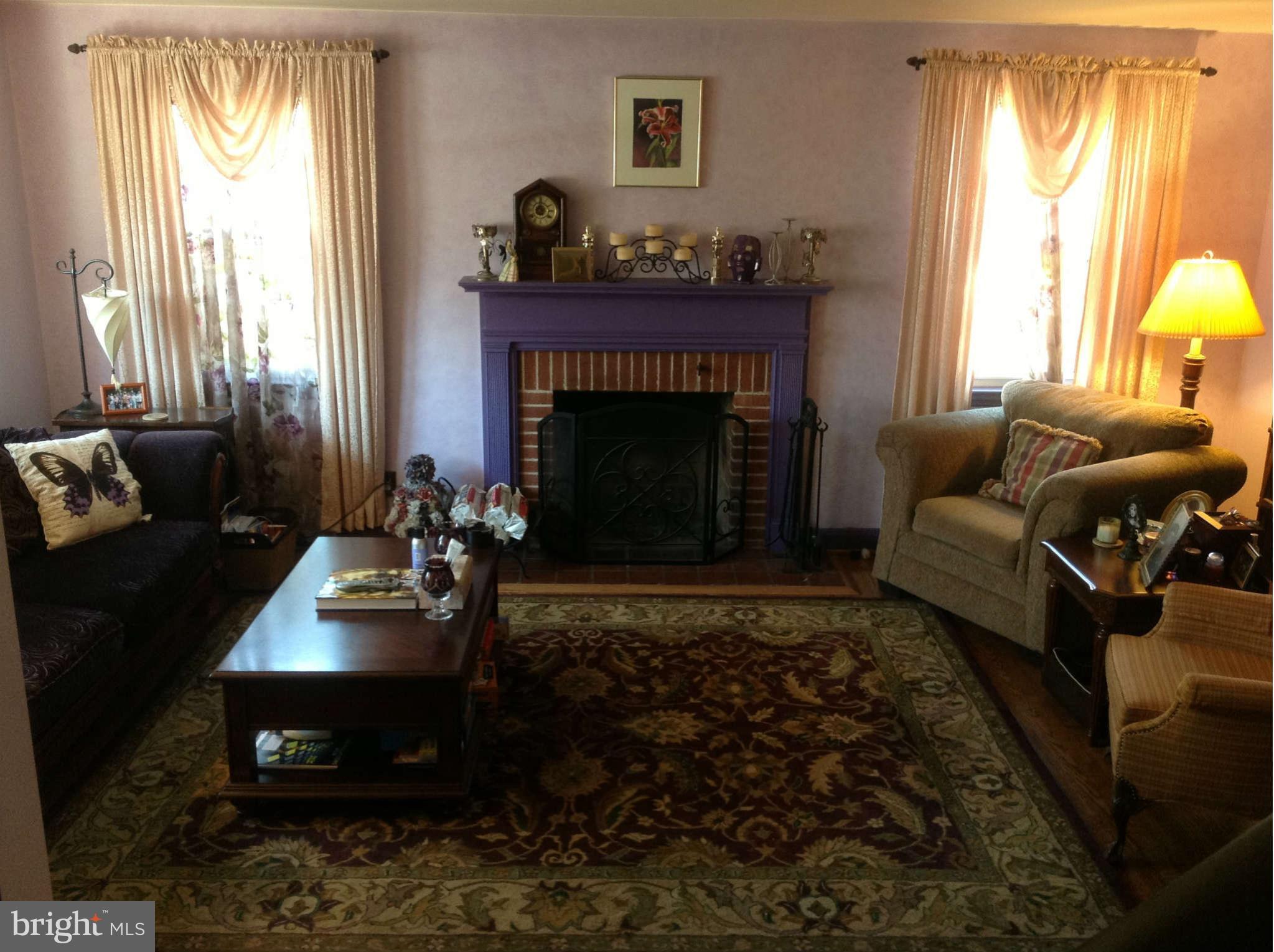 425 Lambeth Road Baltimore, MD 21228 - Photo 4 of 12 a living room with furniture and a fireplace