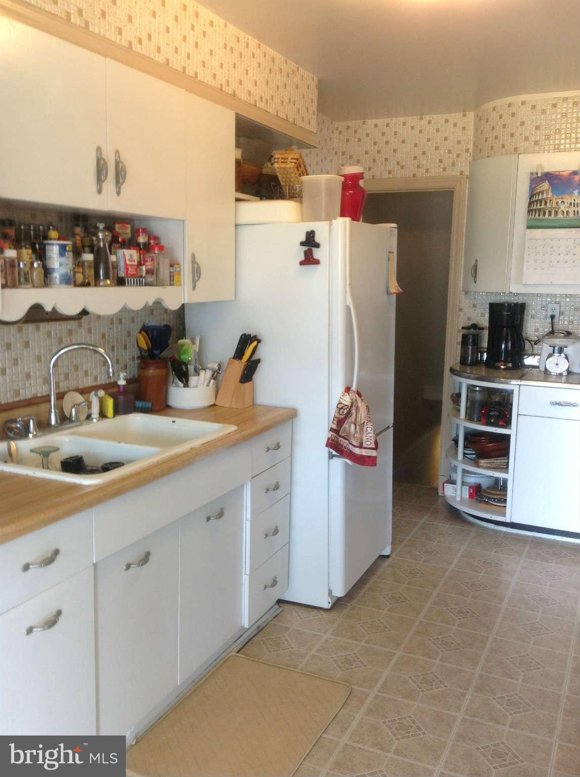 425 Lambeth Road Baltimore, MD 21228 - Photo 5 of 12 a kitchen with a sink and cabinets