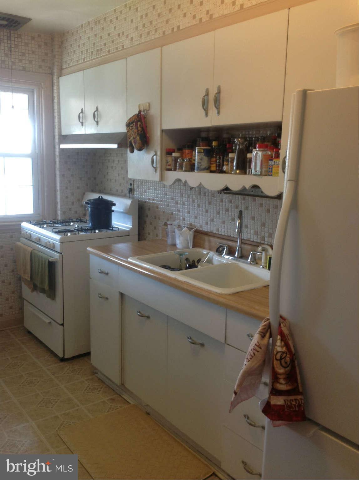 425 Lambeth Road Baltimore, MD 21228 - Photo 6 of 12 a kitchen with stainless steel appliances a sink stove and cabinets