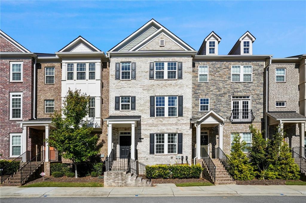 a view of a large brick building next to a yard