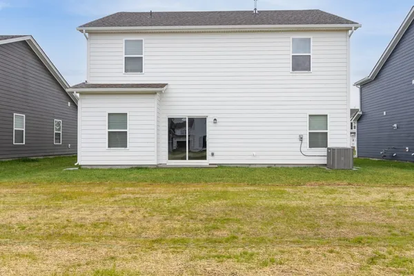 a view of a house with a backyard