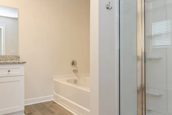 a white bath tub sitting next to a white sink