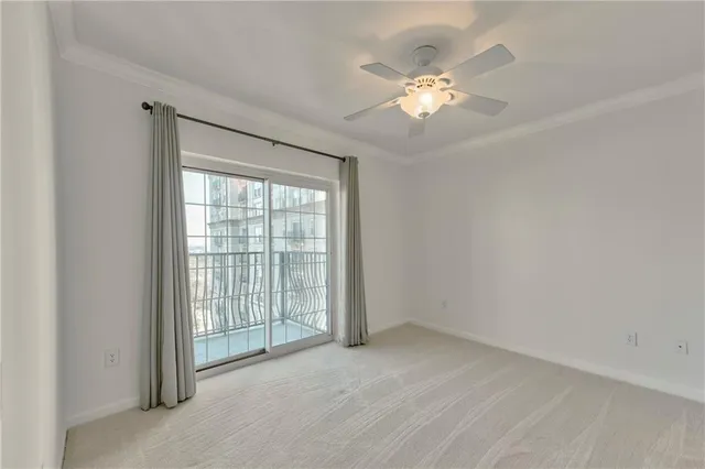 a view of a livingroom with a ceiling fan and window
