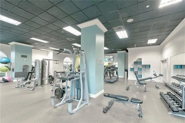 a living room with furniture a flat screen tv and a large window