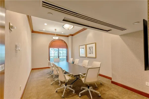 a dining room with furniture and a chandelier
