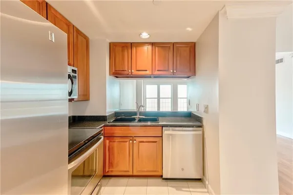 a kitchen with granite countertop a sink and a stove