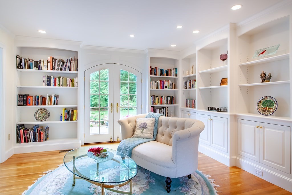 106 Hidden Valley Road Groton, MA 01450 - Photo 16 of 40 a living room with furniture and a book shelf