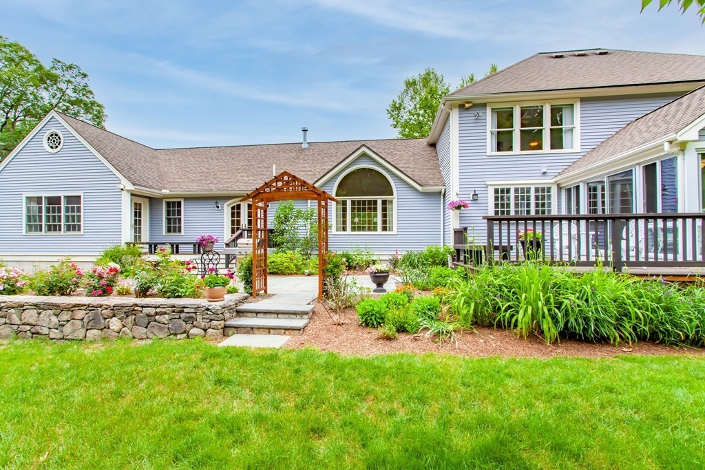 106 Hidden Valley Road Groton, MA 01450 - Photo 2 of 40 a front view of a house with a garden