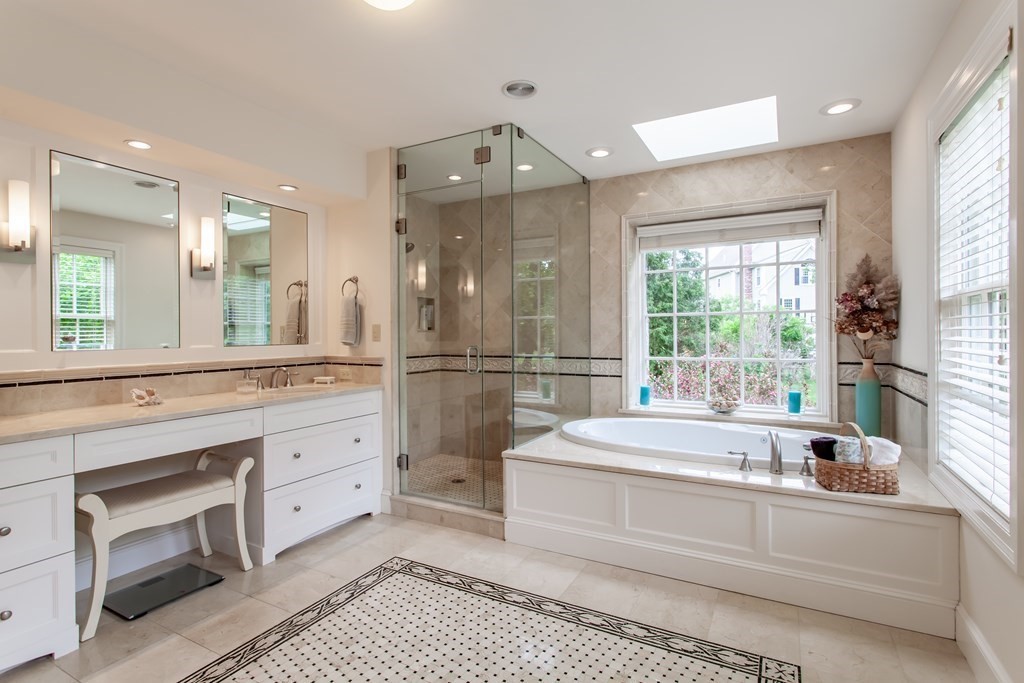 106 Hidden Valley Road Groton, MA 01450 - Photo 21 of 40 a spacious bathroom with a double vanity sink a mirror and a bathtub