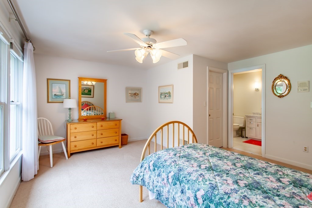 106 Hidden Valley Road Groton, MA 01450 - Photo 23 of 40 a bedroom with furniture and a chandelier
