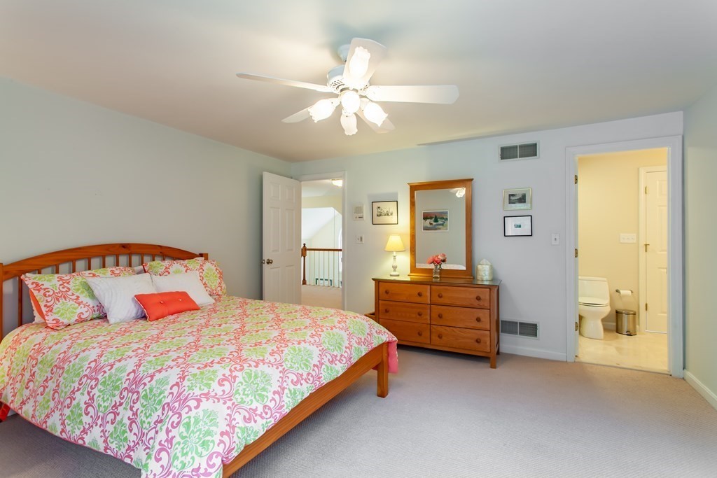 106 Hidden Valley Road Groton, MA 01450 - Photo 26 of 40 a bedroom with a bed and wooden floor