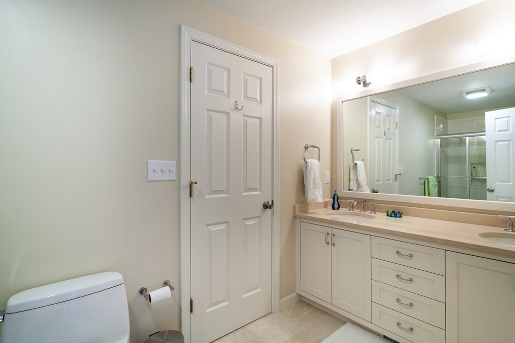 106 Hidden Valley Road Groton, MA 01450 - Photo 27 of 40 a spacious bathroom with a toilet a sink a mirror and a shower
