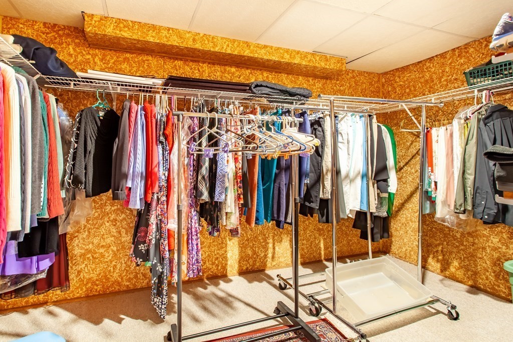 106 Hidden Valley Road Groton, MA 01450 - Photo 31 of 40 a view of walk in closet with clothes