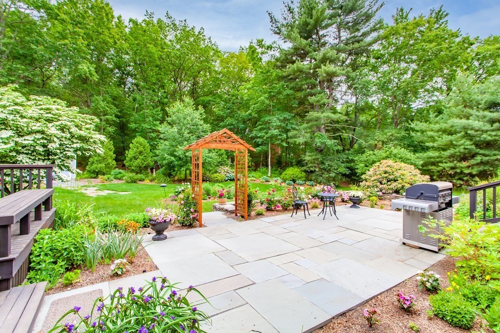 106 Hidden Valley Road Groton, MA 01450 - Photo 32 of 40 a view of a chair and table in the garden