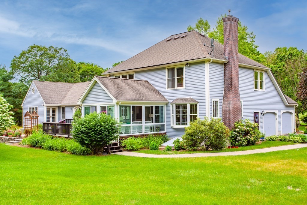 106 Hidden Valley Road Groton, MA 01450 - Photo 35 of 40 a front view of a house with a garden
