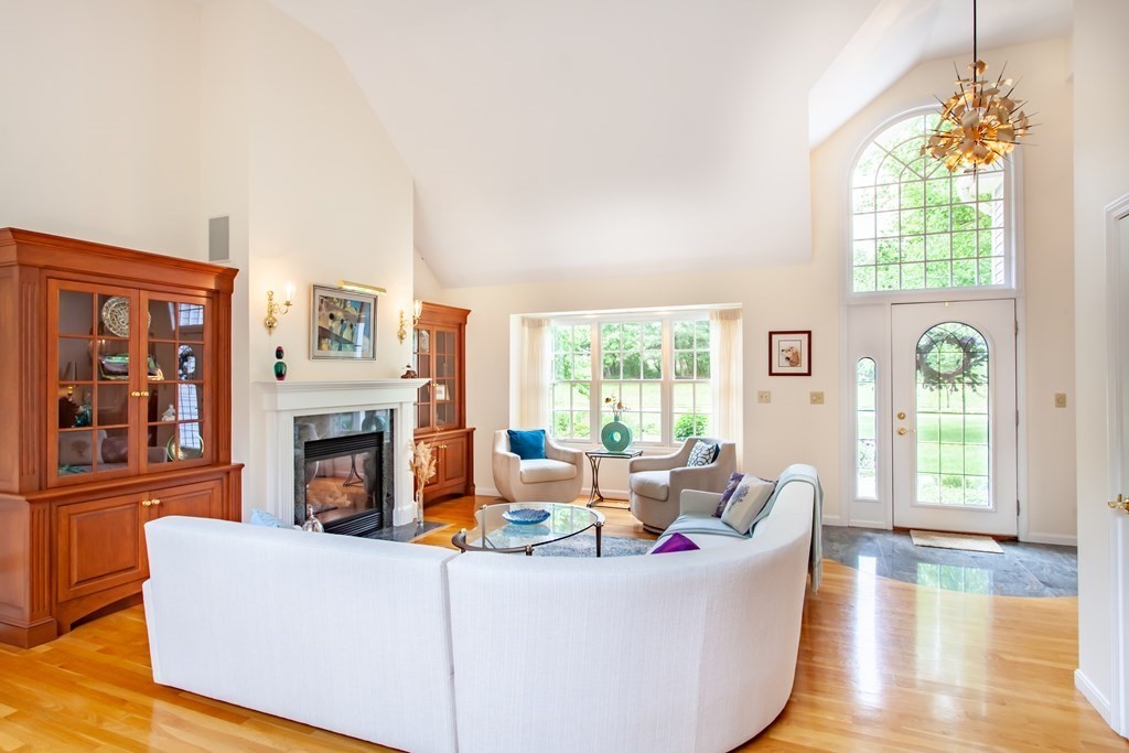 106 Hidden Valley Road Groton, MA 01450 - Photo 6 of 40 a living room with fireplace furniture and a wooden floor