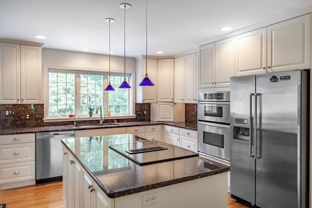 106 Hidden Valley Road Groton, MA 01450 - Photo 9 of 40 a kitchen with stainless steel appliances granite countertop a refrigerator a sink and white cabinets