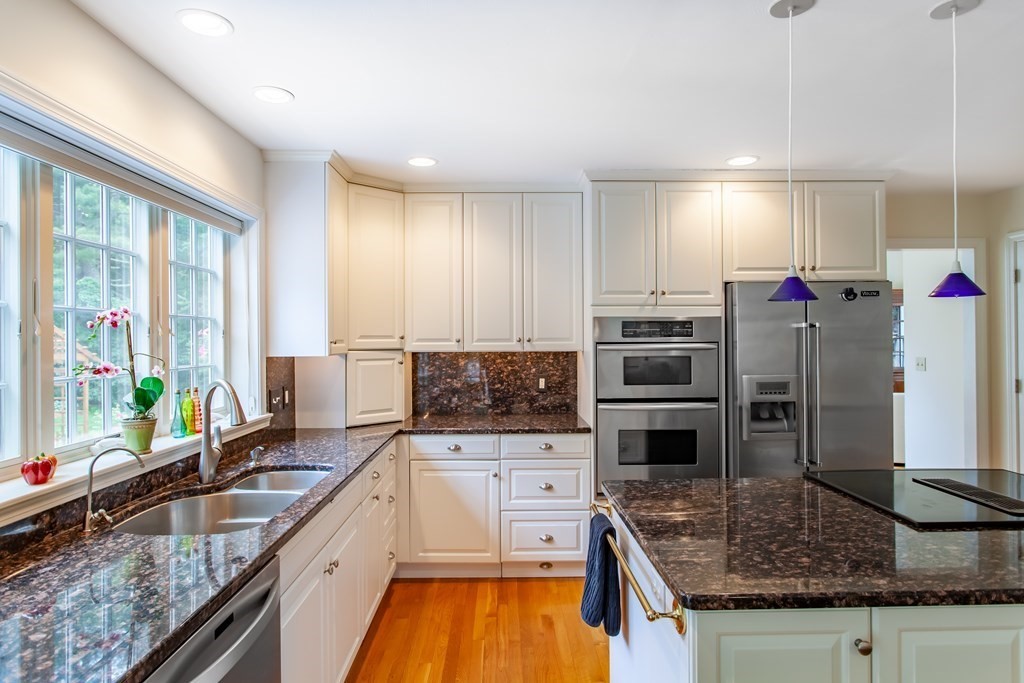 106 Hidden Valley Road Groton, MA 01450 - Photo 10 of 40 a kitchen with stainless steel appliances granite countertop a sink stove and refrigerator