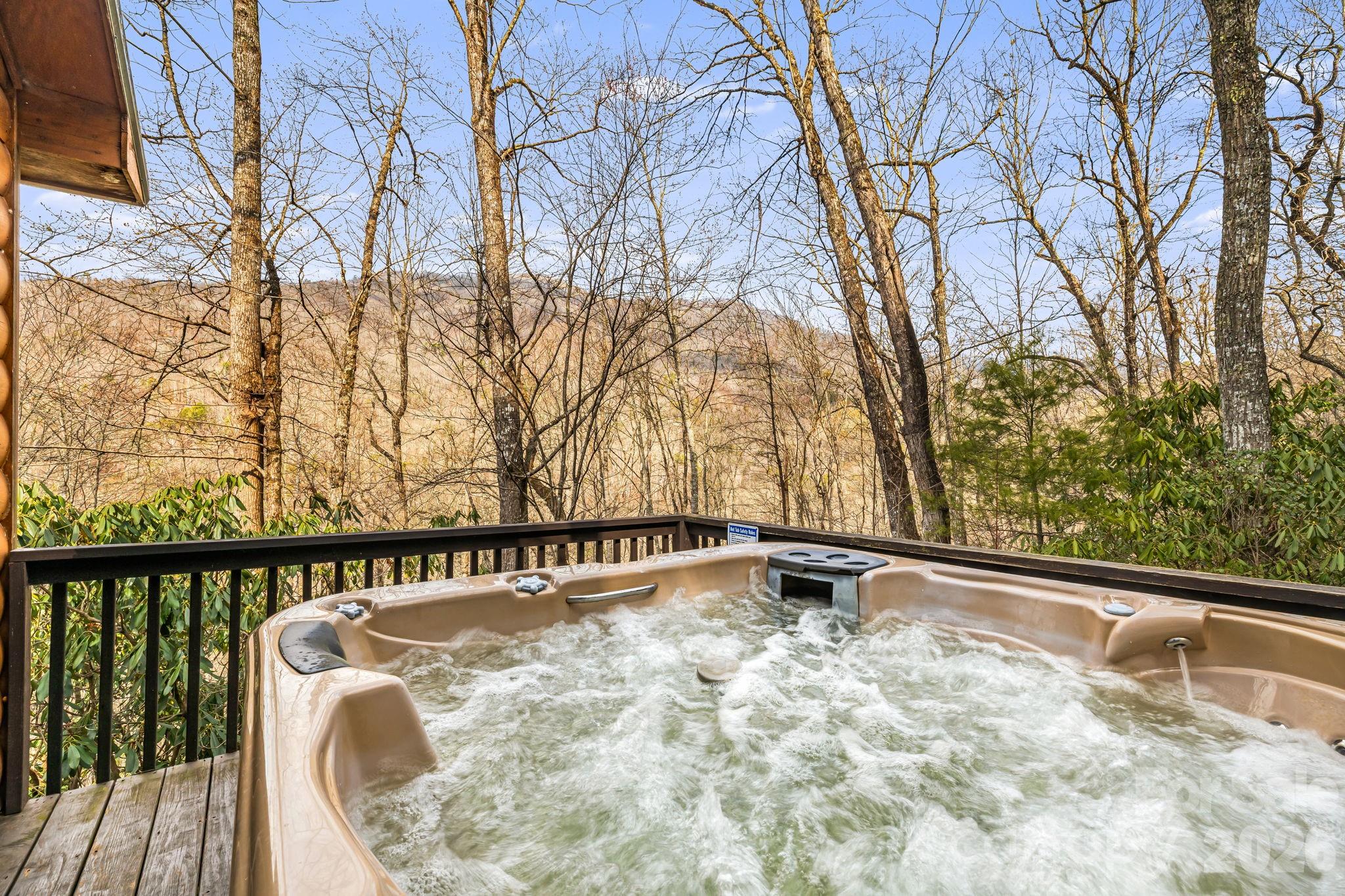 157 Crosspatch Lane Bryson City, NC 28713 - Photo 2 of 38 a view of a roof deck with wooden fence and large trees