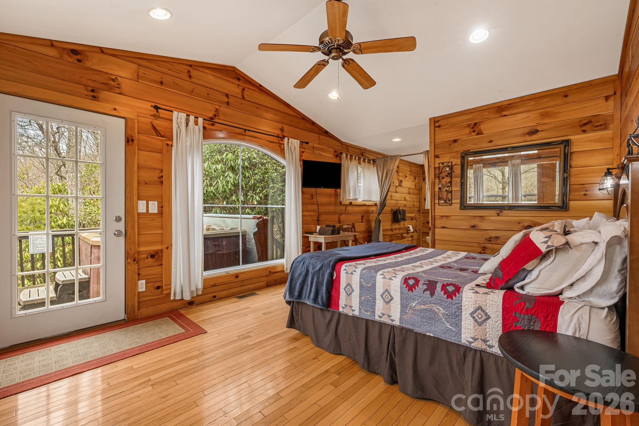 157 Crosspatch Lane Bryson City, NC 28713 - Photo 24 of 38 a bedroom with bed and wooden floor