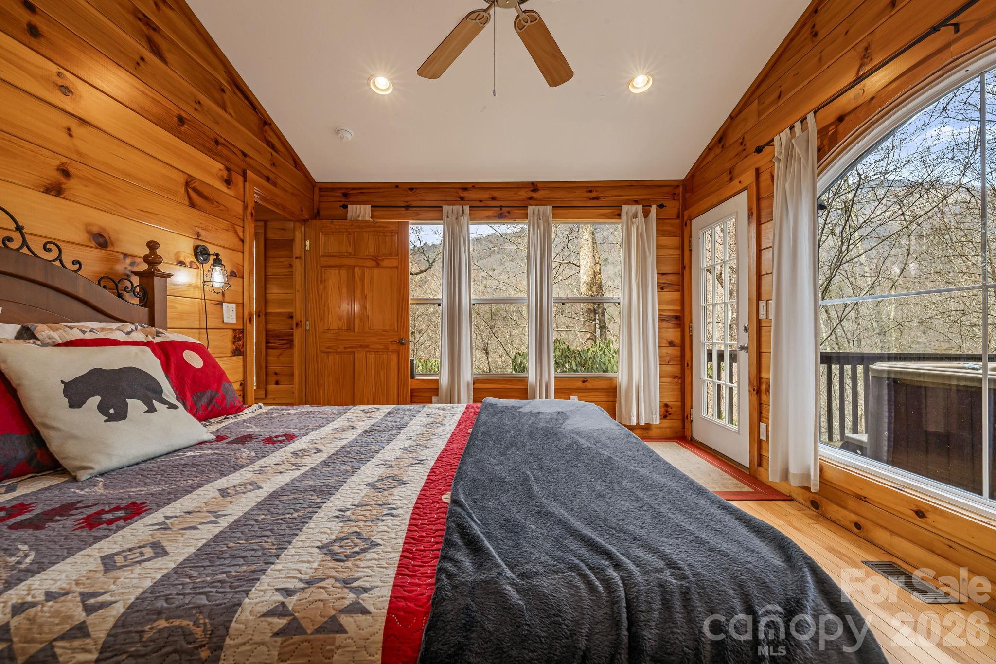 157 Crosspatch Lane Bryson City, NC 28713 - Photo 25 of 38 a bedroom with a large bed and a large window