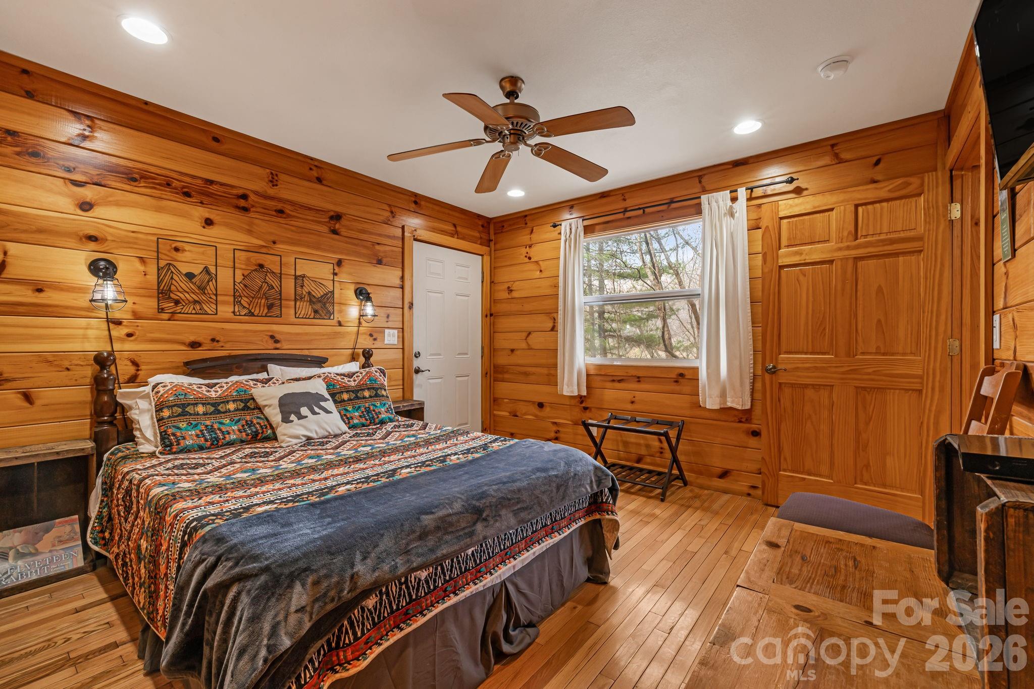 157 Crosspatch Lane Bryson City, NC 28713 - Photo 28 of 38 a bedroom with a bed and wooden floor