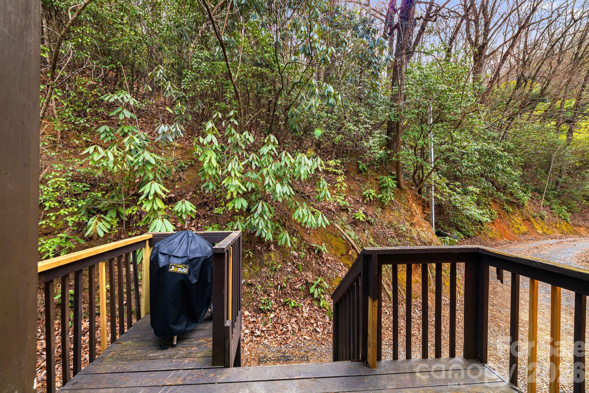 157 Crosspatch Lane Bryson City, NC 28713 - Photo 33 of 38 a balcony with wooden floor and trees