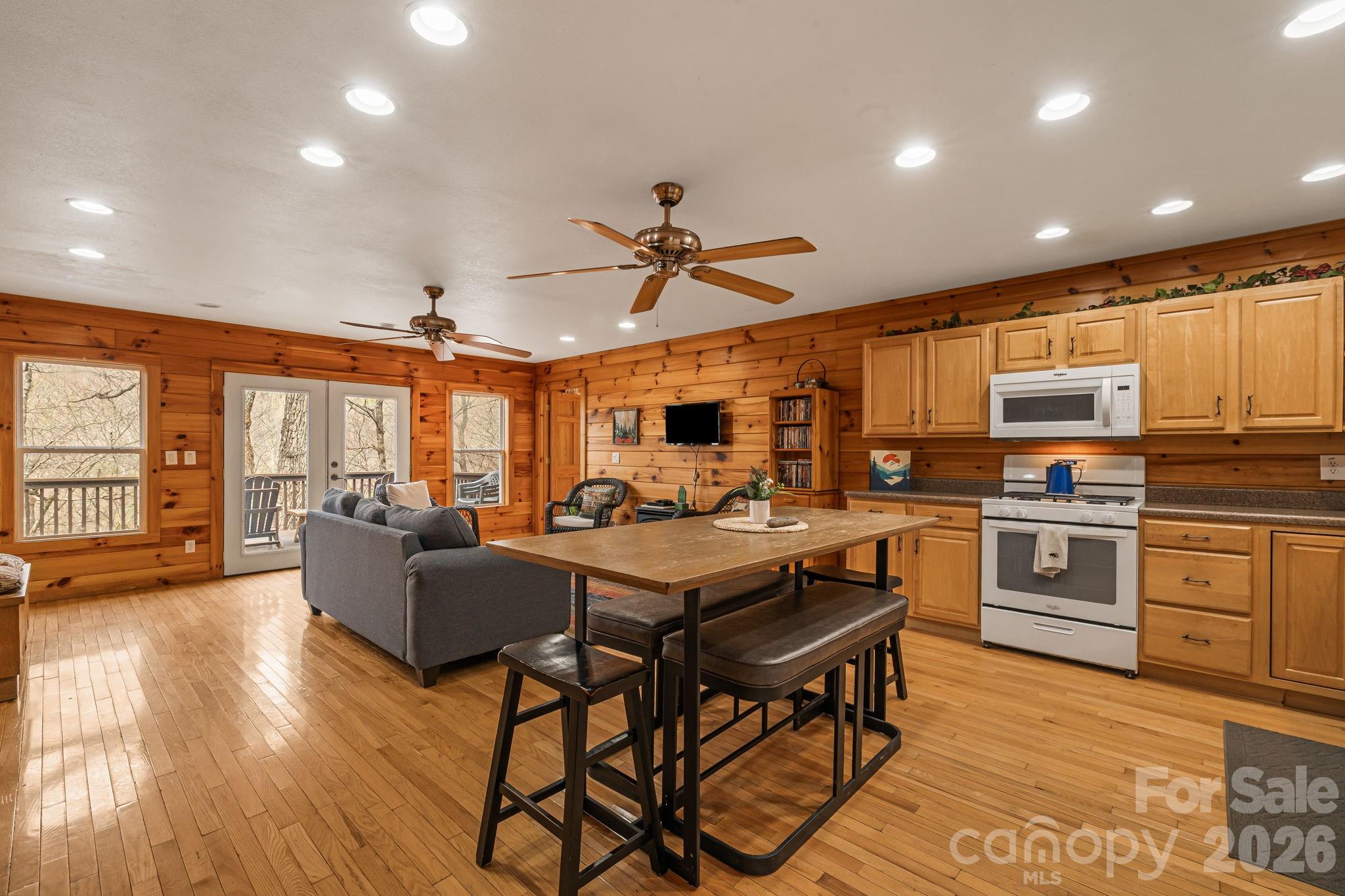 157 Crosspatch Lane Bryson City, NC 28713 - Photo 10 of 38 a kitchen with a table chairs stove and cabinets