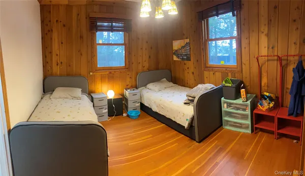 a bedroom with two beds and painted walls