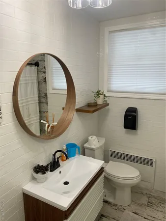 a bathroom with a sink a mirror and a toilet