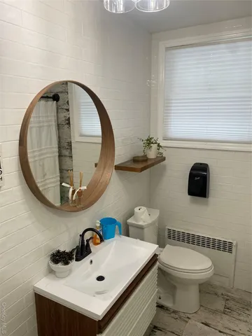 a bathroom with a sink a mirror and a toilet