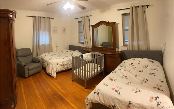 a bedroom with two beds and a dresser