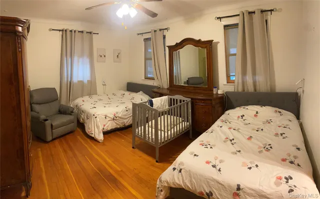 a bedroom with two beds and a dresser