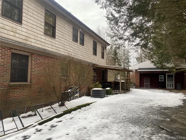 a view of a chair and tables in the back yard of the house