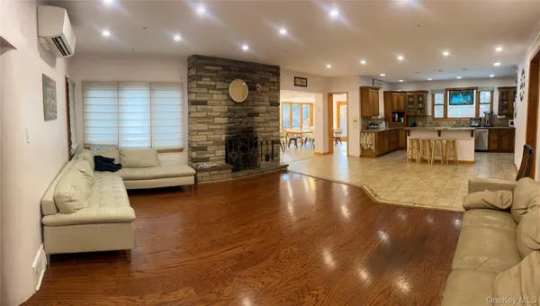 a living room with fireplace furniture and a hard wood floor