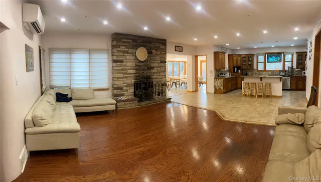 a living room with fireplace furniture and a hard wood floor