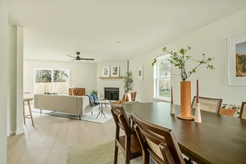 a living room with fireplace furniture and a table