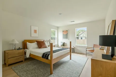 a bedroom with a bed and a couch