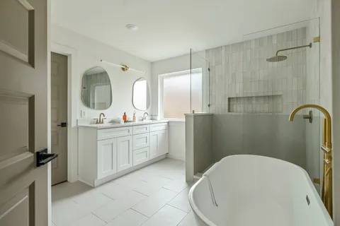 a bathroom with a sink a toilet and a mirror