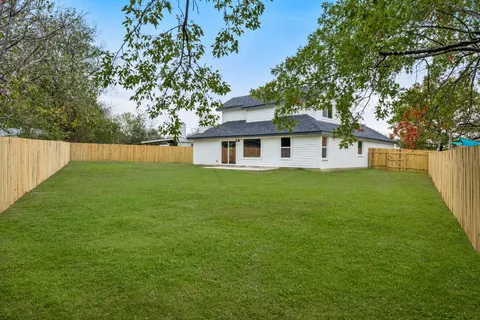 a white house that has a tree in front of it
