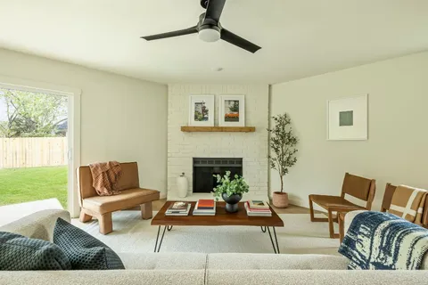 a living room with furniture and a fireplace