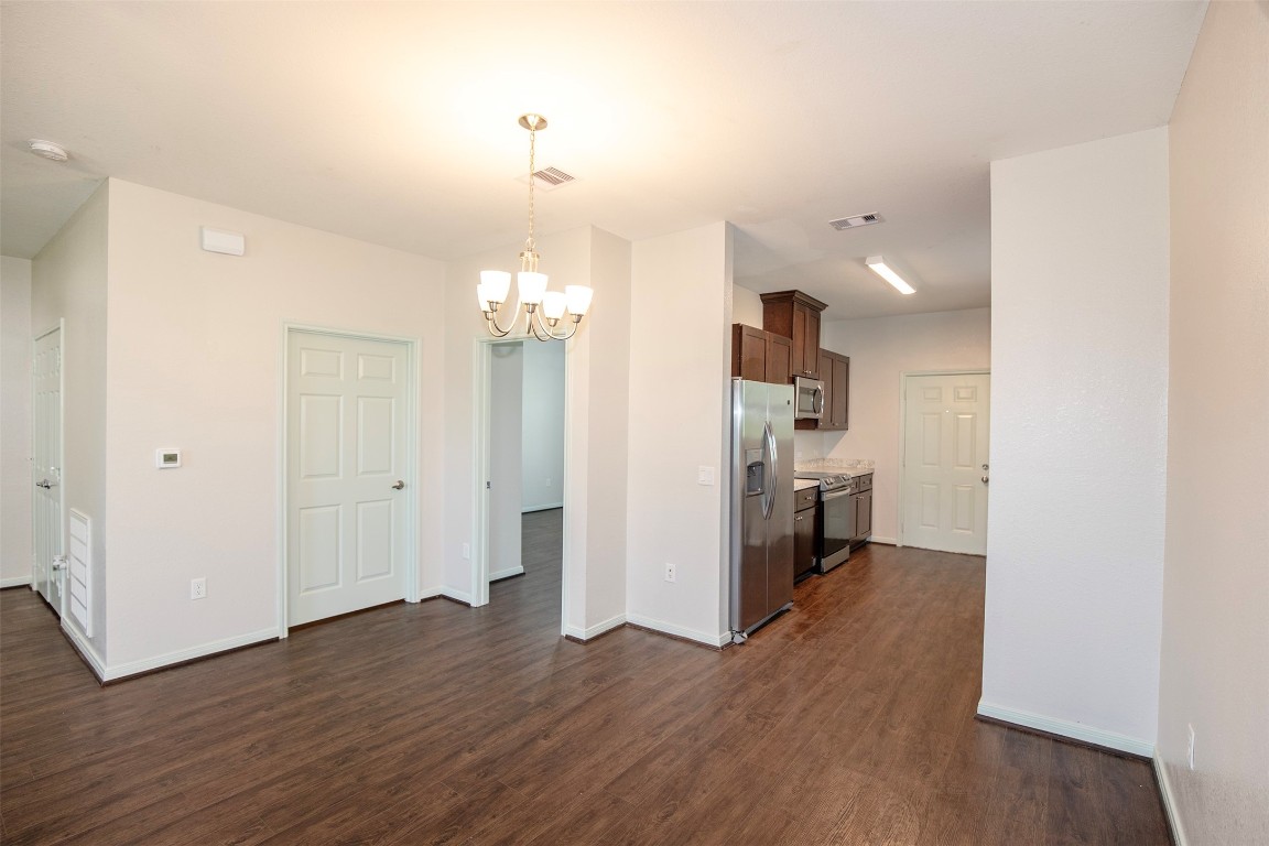 2016 H Avenue Dickinson, TX 77539 - Photo 12 of 30 a view of a kitchen with wooden floor and a refrigerator
