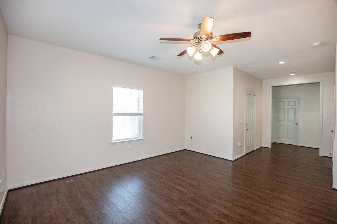 2016 H Avenue Dickinson, TX 77539 - Photo 9 of 30 an empty room with wooden floor fan and windows