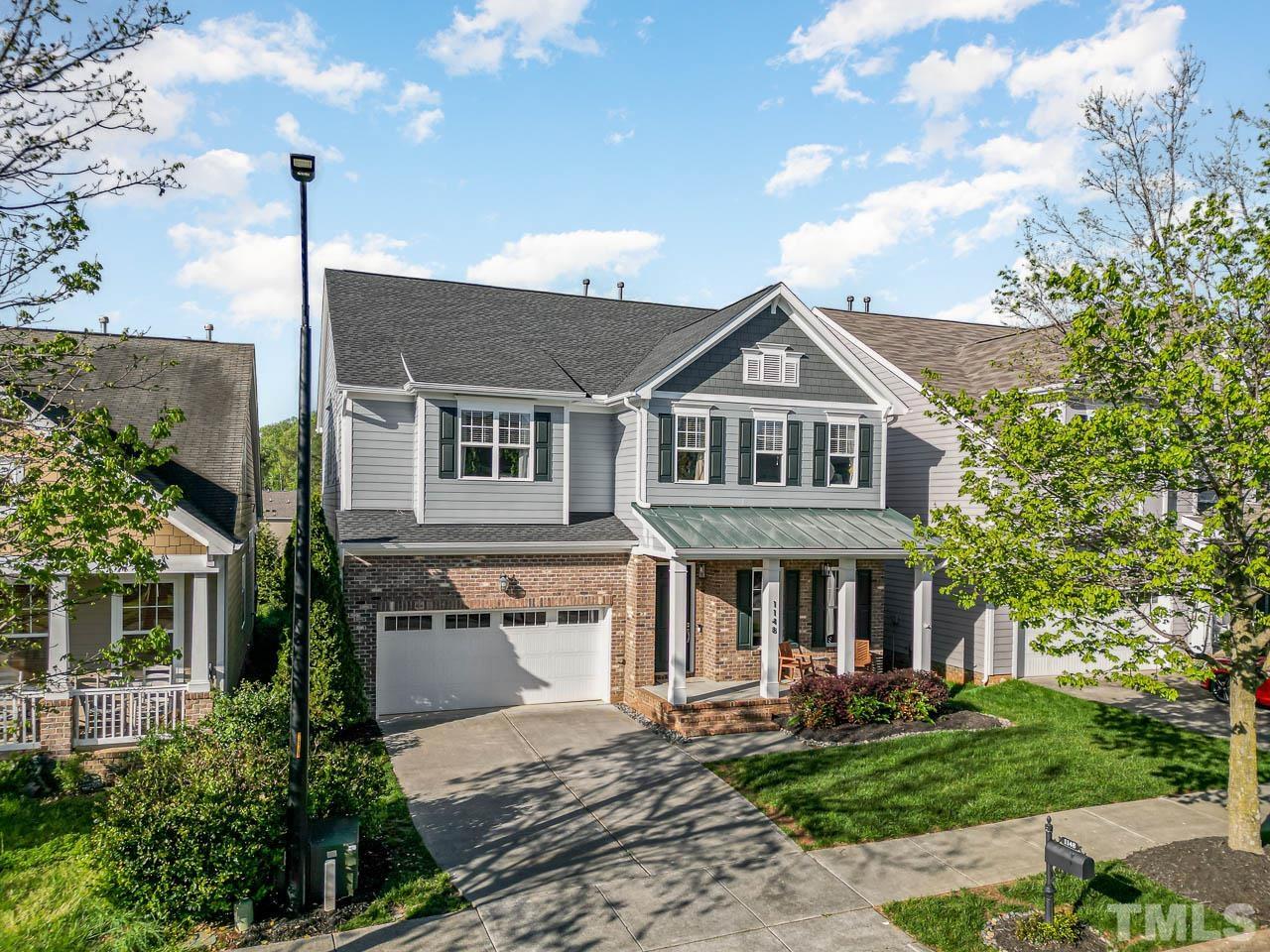 1148 Chapanoke Road Raleigh, NC 27603 - Photo 1 of 47 a front view of a house with garden and porch