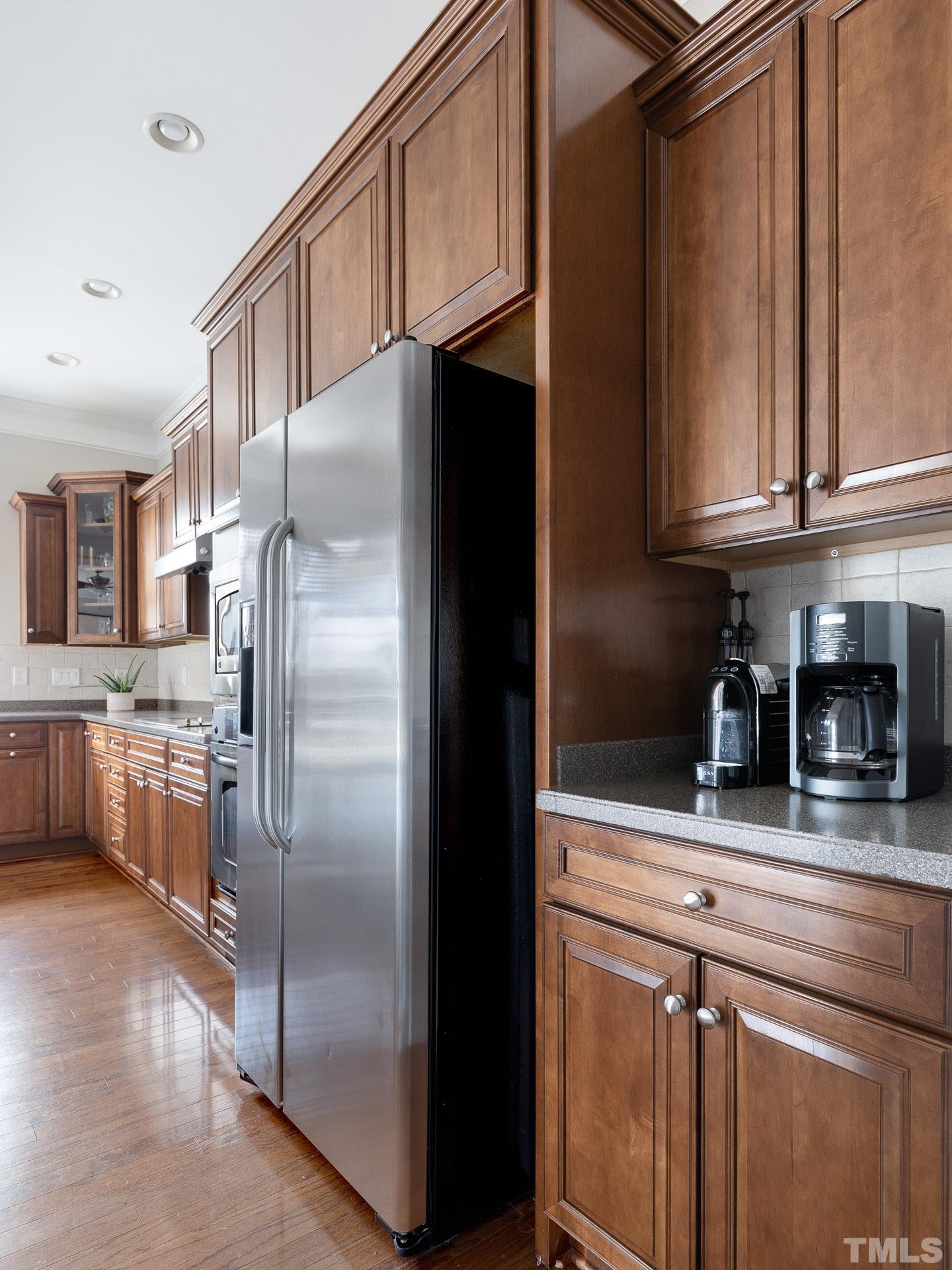 1148 Chapanoke Road Raleigh, NC 27603 - Photo 12 of 47 a kitchen with stainless steel appliances granite countertop a refrigerator a stove and a sink with cabinets