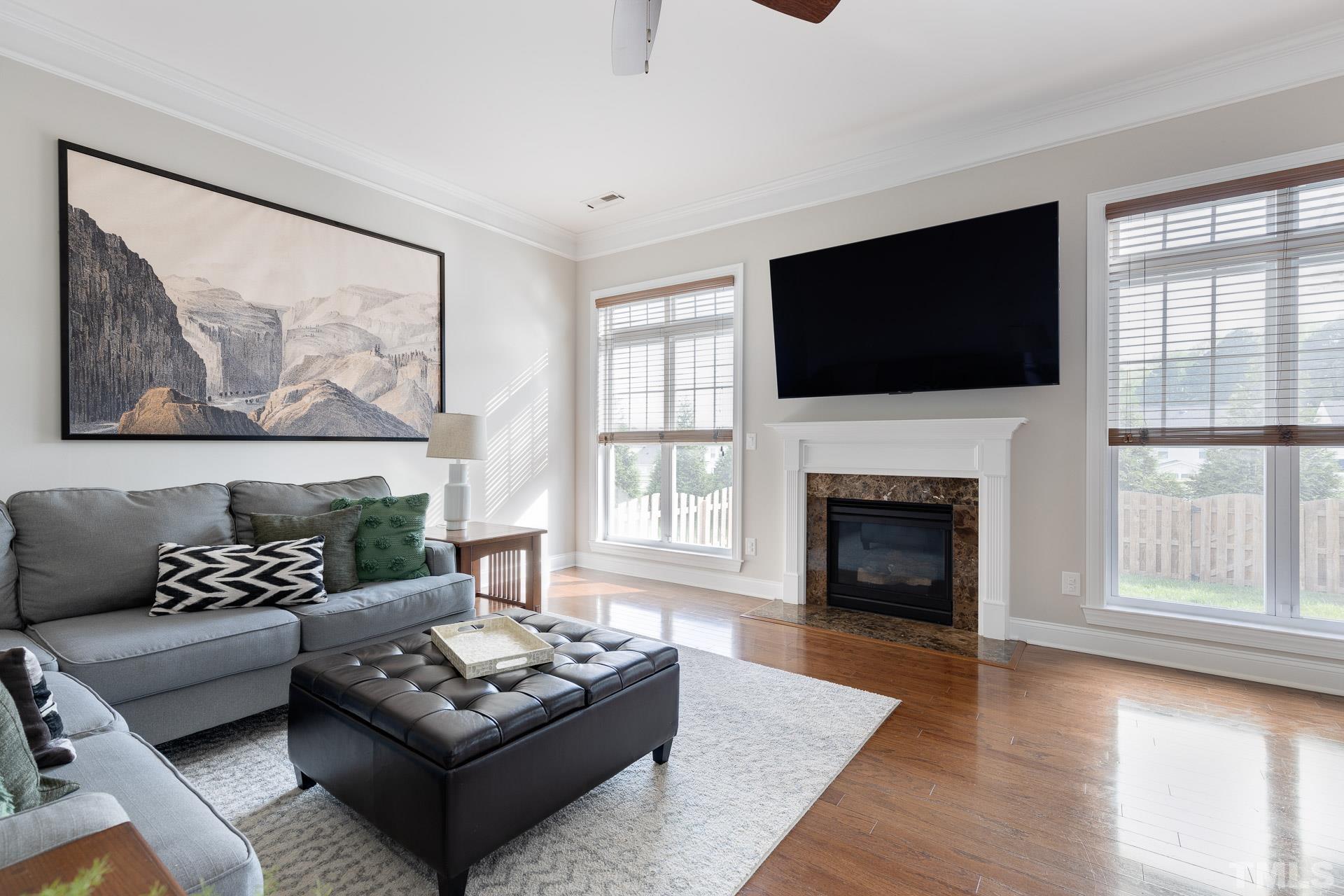 1148 Chapanoke Road Raleigh, NC 27603 - Photo 15 of 47 a living room with furniture a flat screen tv and a fireplace