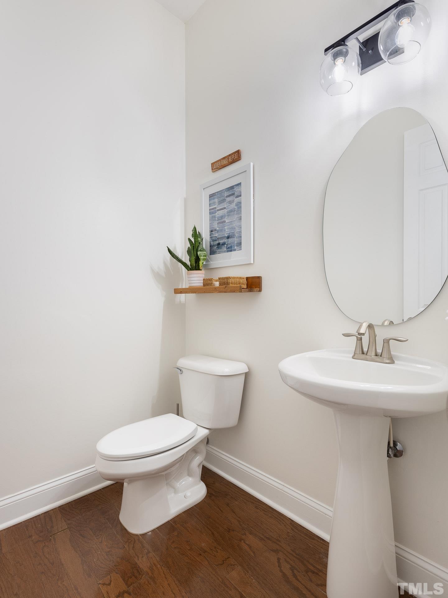 1148 Chapanoke Road Raleigh, NC 27603 - Photo 18 of 47 a bathroom with a toilet a sink and mirror