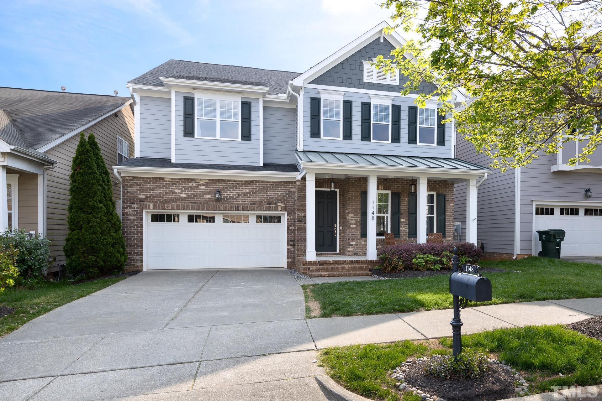 1148 Chapanoke Road Raleigh, NC 27603 - Photo 2 of 47 a front view of a house with garden and plants