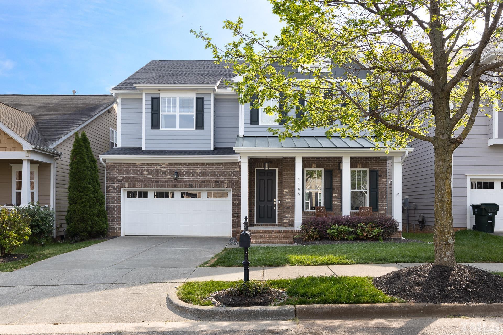 1148 Chapanoke Road Raleigh, NC 27603 - Photo 3 of 47 a front view of a house with a yard and garage