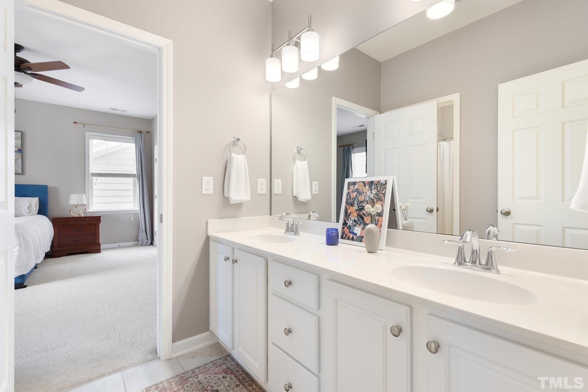 1148 Chapanoke Road Raleigh, NC 27603 - Photo 32 of 47 a bathroom with a double vanity sink mirror and